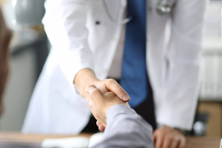 podiatrist shaking patient's hand